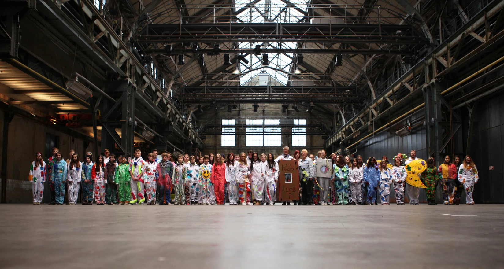 Gruppe Jugendlicher in "Kunst-Overalls"