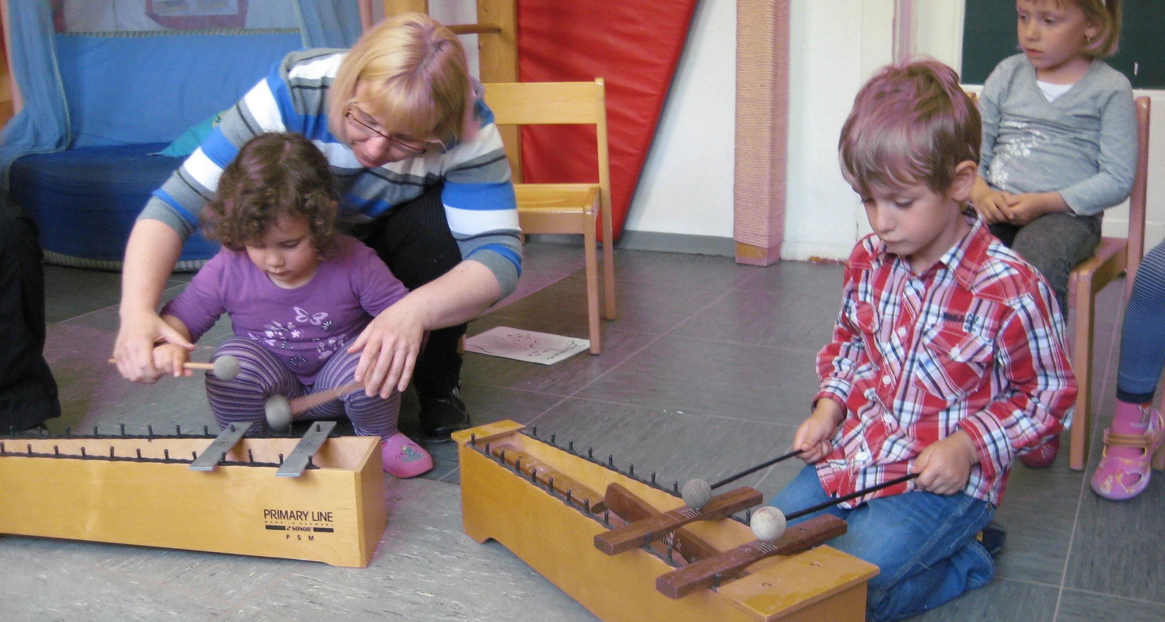 Kinder probieren Klanginstrumente aus