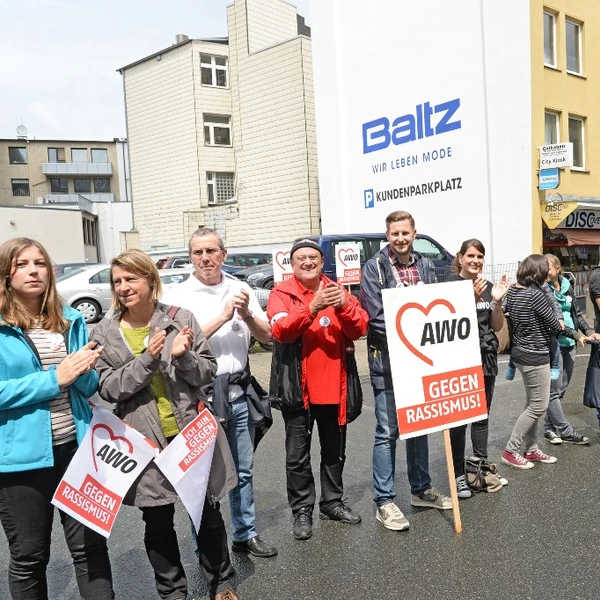 Menschenkette mit Schildern "AWO gegen Rassismus"